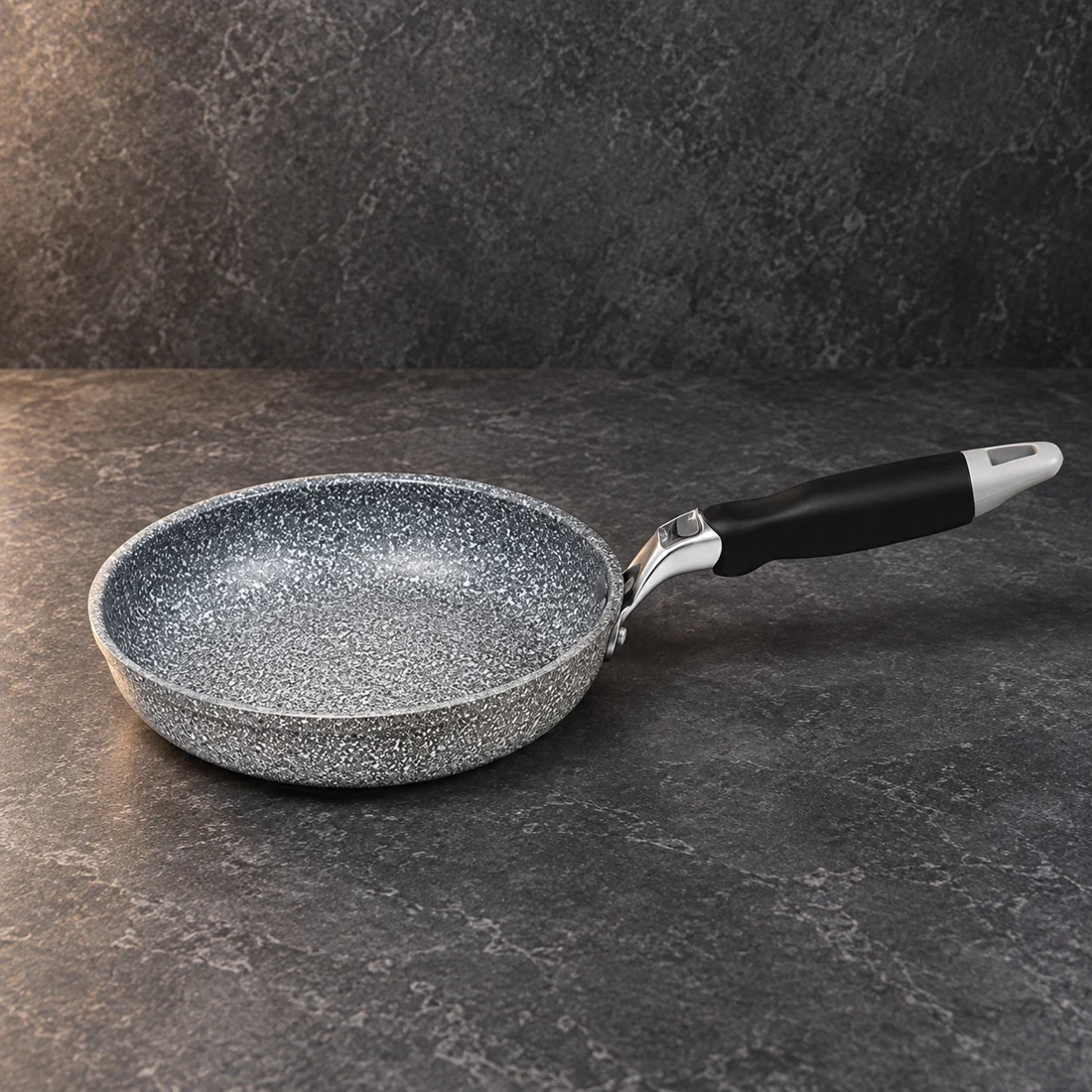 Grey speckled frying pan with a black and silver handle